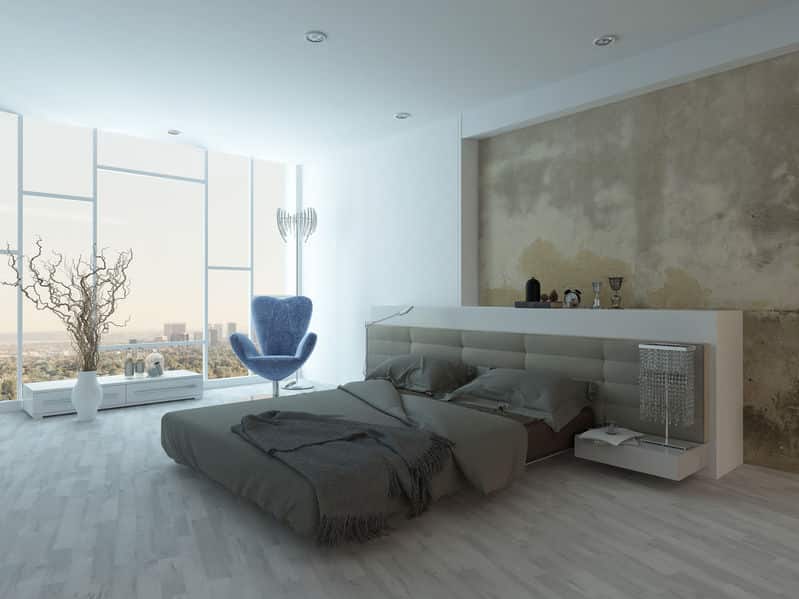 Modern factory style bedroom interior with concrete wall